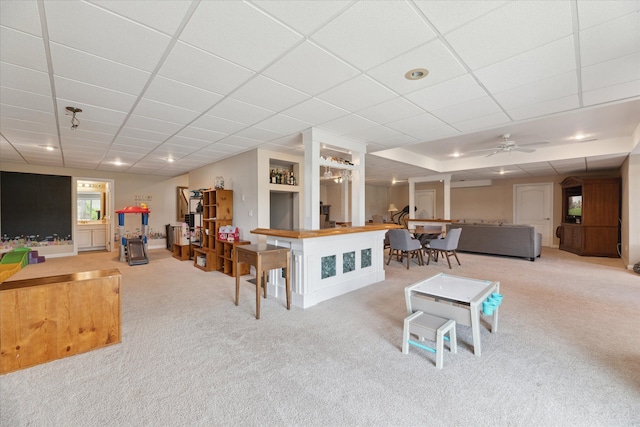 living area with carpet and a ceiling fan