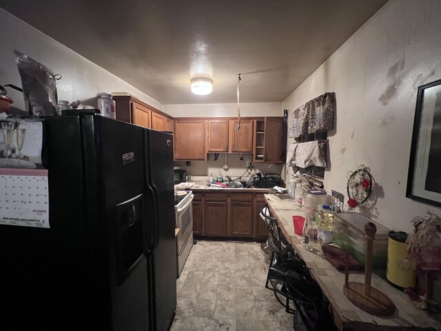 13192 Schoolcraft Rd, Detroit, MI 48227 - kitchen featuring black fridge with ice dispenser, electric stove, tile countertops, brown cabinets, and open shelves