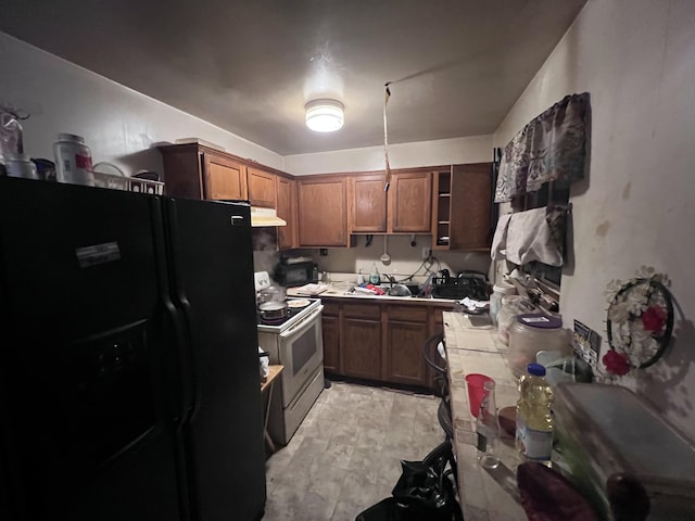 13192 Schoolcraft Rd, Detroit, MI 48227 - kitchen featuring black fridge, tile counters, white range with electric cooktop, under cabinet range hood, and open shelves