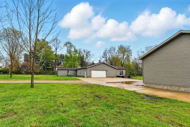 15105 Carpenter Rd, Three Oaks, MI 49128 - view of green lawn featuring driveway and an attached garage