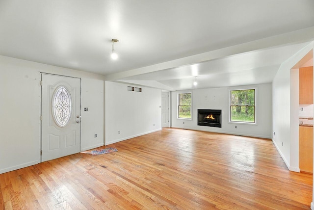 15105 Carpenter Rd, Three Oaks, MI 49128 - unfurnished living room with light wood-type flooring, baseboards, and a warm lit fireplace