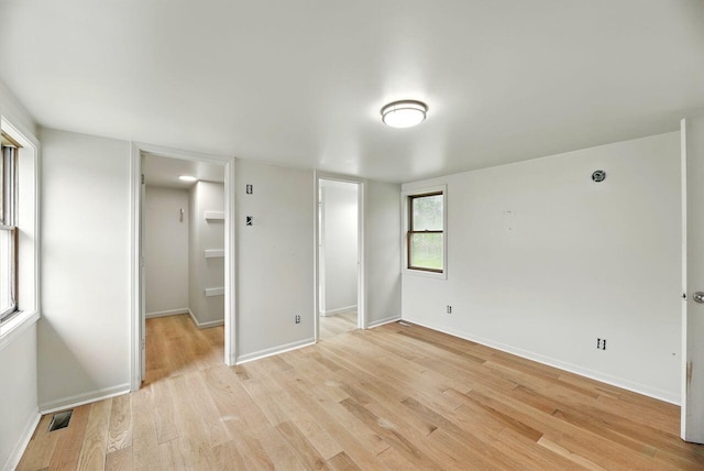 15105 Carpenter Rd, Three Oaks, MI 49128 - unfurnished bedroom featuring a spacious closet, light wood-style floors, baseboards, and a closet