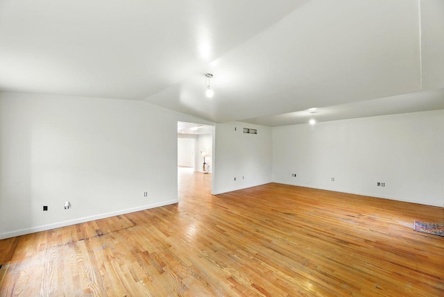 15105 Carpenter Rd, Three Oaks, MI 49128 - empty room featuring vaulted ceiling, light wood-style floors, and baseboards