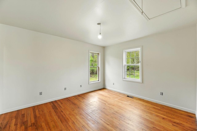 15105 Carpenter Rd, Three Oaks, MI 49128 - spare room featuring baseboards, attic access, and light wood-type flooring