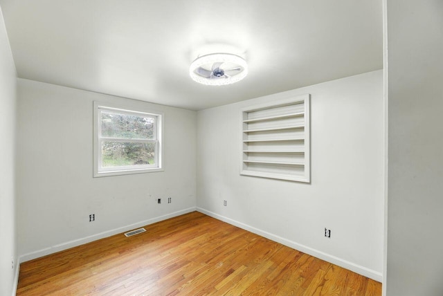 15105 Carpenter Rd, Three Oaks, MI 49128 - spare room featuring light wood finished floors, baseboards, and built in shelves