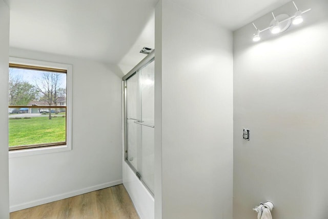 15105 Carpenter Rd, Three Oaks, MI 49128 - bathroom with wood finished floors, shower / bath combination with glass door, and baseboards