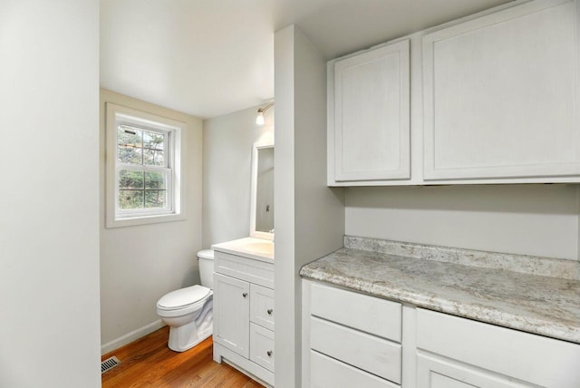 15105 Carpenter Rd, Three Oaks, MI 49128 - half bath with toilet, wood finished floors, vanity, and baseboards
