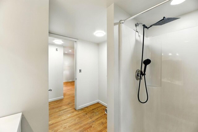 15105 Carpenter Rd, Three Oaks, MI 49128 - full bathroom with wood finished floors, a shower, and baseboards
