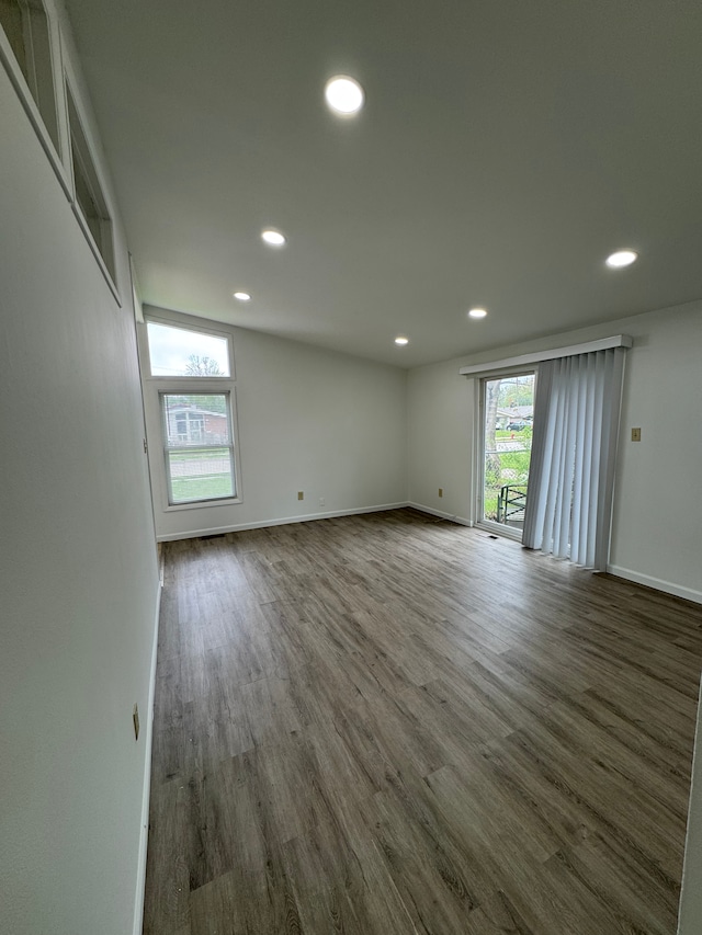 unfurnished room featuring recessed lighting, baseboards, and wood finished floors