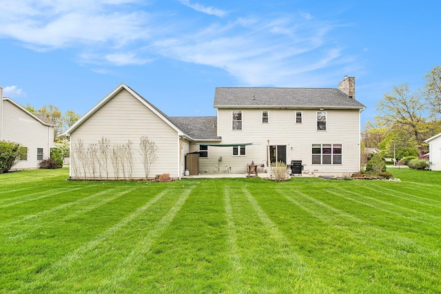 10420 Roger St, Portage, MI 49002 - rear view of house featuring a patio, a lawn, and a chimney