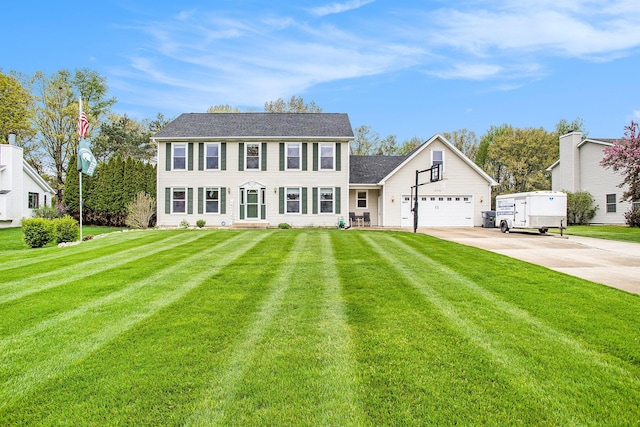 10420 Roger St, Portage, MI 49002 - colonial inspired home featuring driveway, a front lawn, and an attached garage