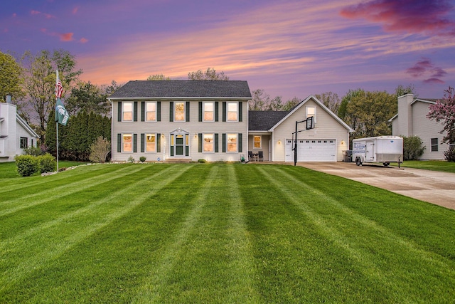 10420 Roger St, Portage, MI 49002 - colonial home with driveway, a yard, and a garage