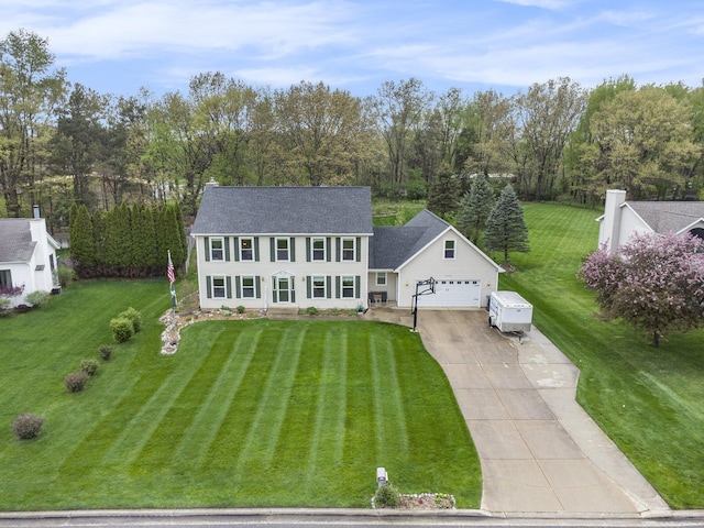 10420 Roger St, Portage, MI 49002 - view of front of house with driveway, a front yard, roof with shingles, an attached garage, and an outdoor structure
