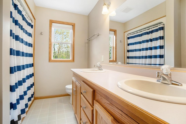 10420 Roger St, Portage, MI 49002 - full bathroom featuring toilet, double vanity, a shower with curtain, and baseboards