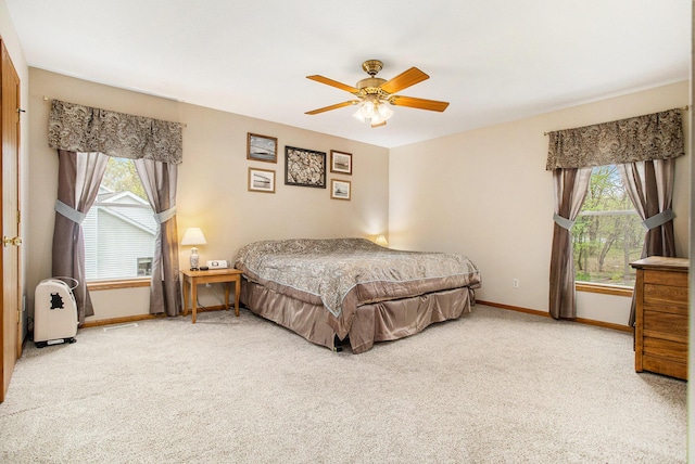 10420 Roger St, Portage, MI 49002 - carpeted bedroom featuring multiple windows, baseboards, and a ceiling fan