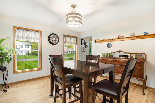 10420 Roger St, Portage, MI 49002 - dining room with light wood-type flooring, baseboards, and a chandelier