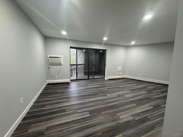 3339 S Cabaret Trl, Saginaw, MI 48603 - unfurnished room featuring a wall unit AC, dark wood finished floors, baseboards, and recessed lighting