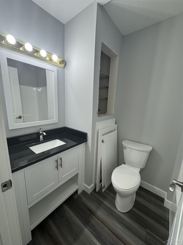 3339 S Cabaret Trl, Saginaw, MI 48603 - bathroom featuring wood finished floors, vanity, toilet, and baseboards