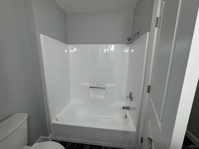 3339 S Cabaret Trl, Saginaw, MI 48603 - bathroom with toilet,  shower combination, baseboards, and wood finished floors