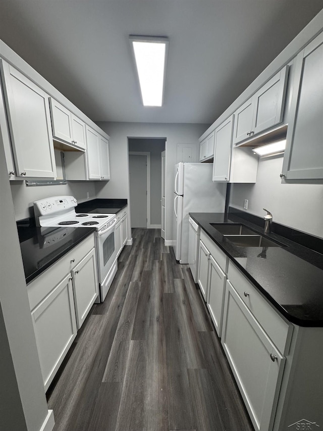 3339 S Cabaret Trl, Saginaw, MI 48603 - kitchen featuring white appliances, dark countertops, a sink, and dark wood-style flooring