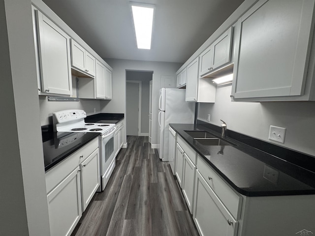 3339 S Cabaret Trl, Saginaw, MI 48603 - kitchen with white appliances, a sink, dark countertops, dark wood finished floors, and white cabinets