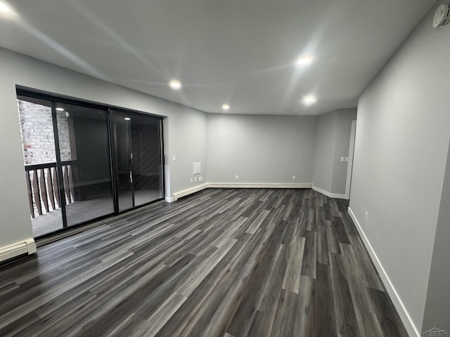 3339 S Cabaret Trl, Saginaw, MI 48603 - empty room featuring dark wood finished floors, baseboards, recessed lighting, and baseboard heating