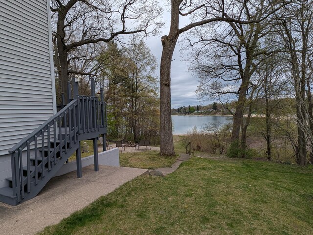 view of grassy yard with a water view