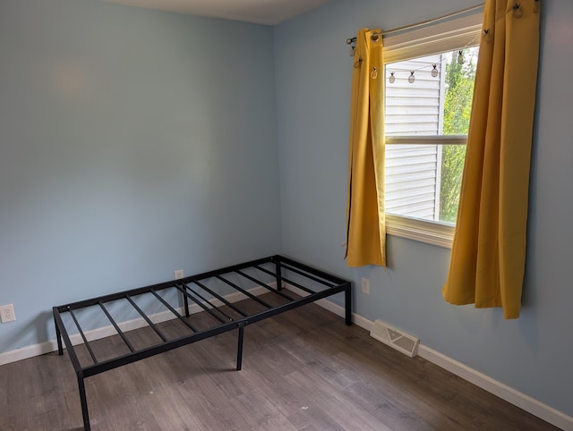 5657 Harding Ave, Muskegon, MI 49442 - unfurnished bedroom with wood finished floors and baseboards