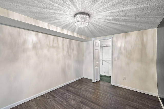 5657 Harding Ave, Muskegon, MI 49442 - unfurnished bedroom with a chandelier and dark wood-type flooring