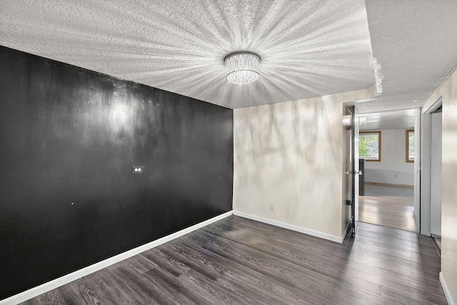 5657 Harding Ave, Muskegon, MI 49442 - unfurnished room featuring wood finished floors, a textured ceiling, and a chandelier