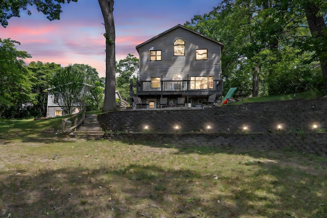 5657 Harding Ave, Muskegon, MI 49442 - back of house featuring a wooden deck and a lawn