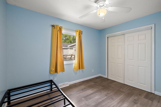5657 Harding Ave, Muskegon, MI 49442 - unfurnished bedroom with wood finished floors, a closet, and ceiling fan