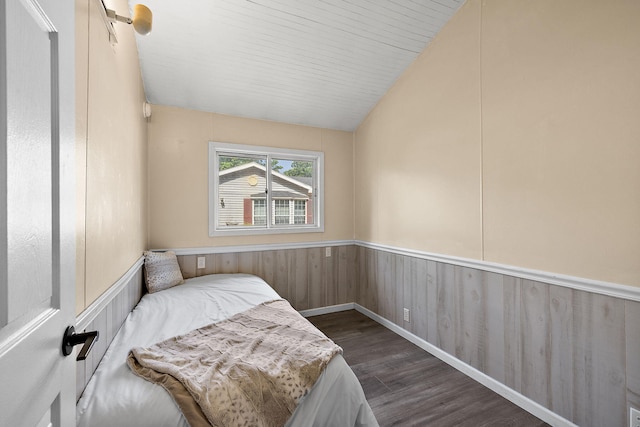 5657 Harding Ave, Muskegon, MI 49442 - bedroom featuring dark wood-style flooring, a wainscoted wall, lofted ceiling, and wood walls