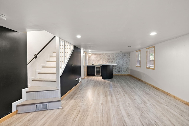 5657 Harding Ave, Muskegon, MI 49442 - unfurnished living room with light wood finished floors, stairs, bar, wine cooler, and recessed lighting