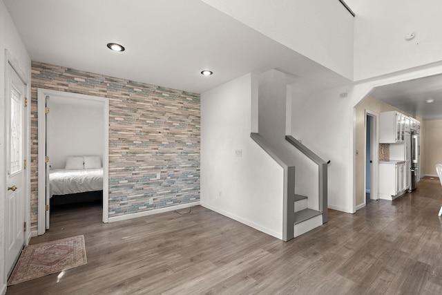 5657 Harding Ave, Muskegon, MI 49442 - unfurnished living room featuring wood finished floors, stairs, and recessed lighting
