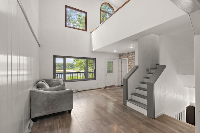 5657 Harding Ave, Muskegon, MI 49442 - living room with a high ceiling, wood finished floors, and stairs