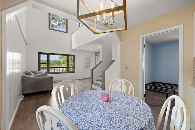 5657 Harding Ave, Muskegon, MI 49442 - dining space with wood finished floors, stairway, and a chandelier
