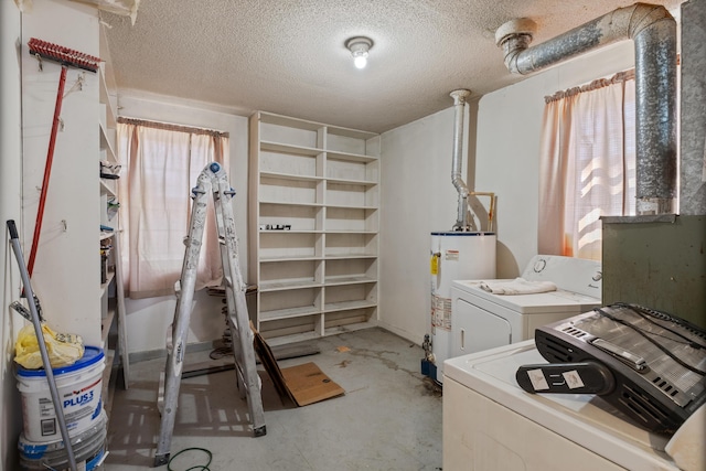 basement with gas water heater, washing machine and clothes dryer, and a textured ceiling