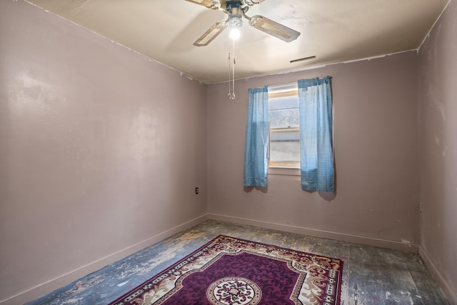 empty room with ceiling fan and baseboards