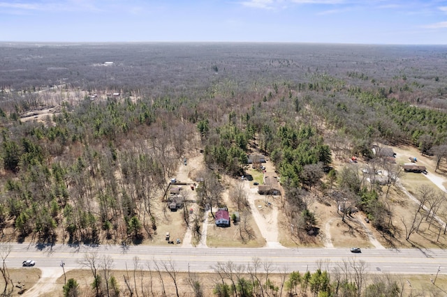 aerial view of property's location with a heavily wooded area
