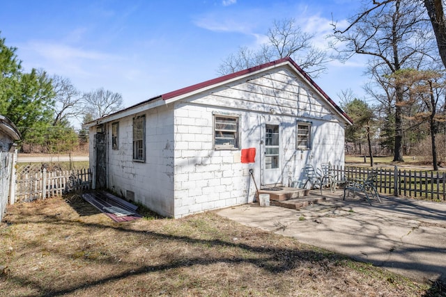 view of outbuilding with fence