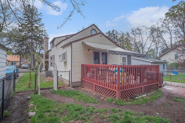 back of house featuring a gate, fence, and a deck