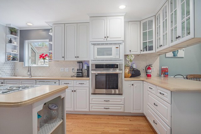 kitchen with open shelves, white appliances, light countertops, white cabinets, and recessed lighting