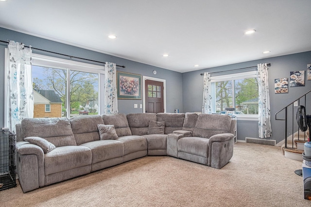 carpeted living area with recessed lighting, healthy amount of natural light, baseboards, and stairway