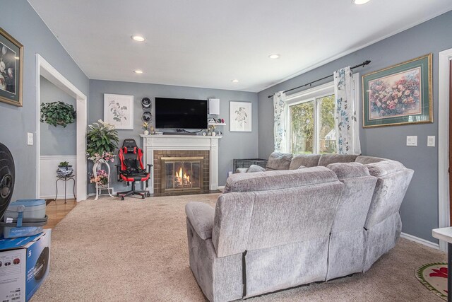 living room featuring recessed lighting, a fireplace, carpet, and baseboards