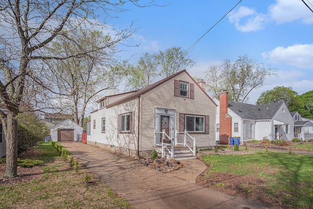 bungalow-style house with asphalt driveway, an outdoor structure, a garage, cooling unit, and a chimney