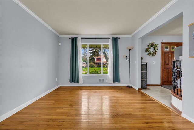 18579 Jeanette St, Southfield, MI 48075 - spare room featuring light wood-type flooring, ornamental molding, and baseboards