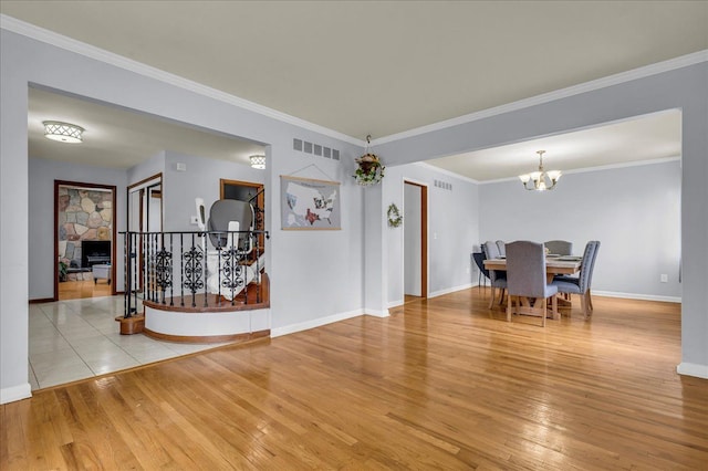 18579 Jeanette St, Southfield, MI 48075 - dining area with hardwood / wood-style flooring, a chandelier, baseboards, and crown molding