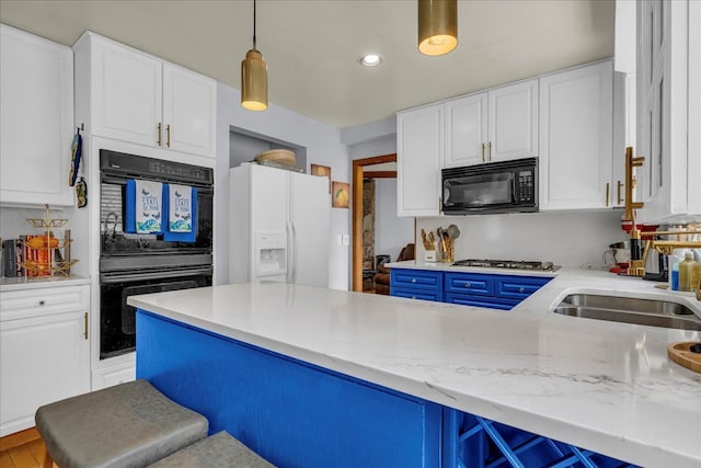 18579 Jeanette St, Southfield, MI 48075 - kitchen featuring black appliances, white cabinetry, hanging light fixtures, blue cabinets, and light stone countertops