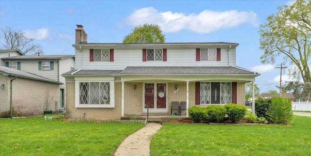 18579 Jeanette St, Southfield, MI 48075 - traditional-style home featuring brick siding, a front lawn, a chimney, and covered porch